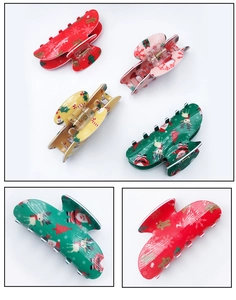 Set of four colorful Christmas hair claws featuring reindeer and snowman patterns on white
