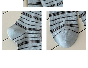 Detailed macro view of light blue striped cotton socks showing breathable mesh and stitching