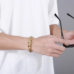 Men's bold dragon scale link bracelet in gold-plated stainless steel on male wrist