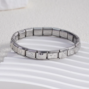 Detail of Italian charm bracelet links showing star, heart, and clover engravings