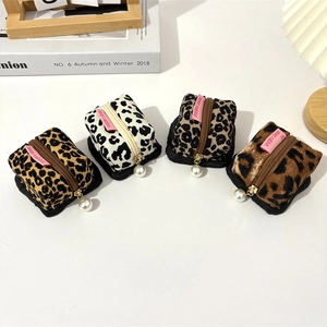 Vintage corduroy earphone pouches in leopard and cow patterns with pearl charms