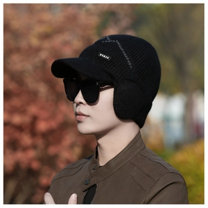 Detail of black men's winter knit visor hat with ear flaps and NY&JA branded label