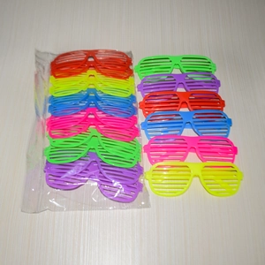 Colorful shutter shades pack for parties showing various plastic neon glasses on a table