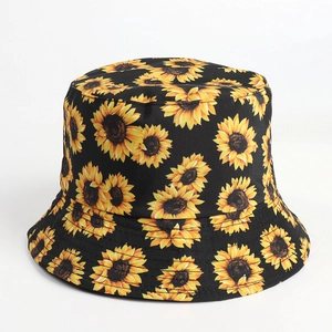 Detail view of the yellow sunflower print on a black canvas reversible bucket hat
