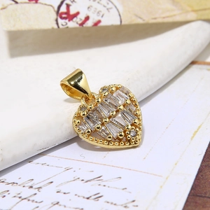 Elegant gold heart pendant necklace with baguette-cut zircon inlay on vintage background