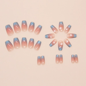Detailed view of sky blue cat-eye press-on nails with white cloud and star patterns