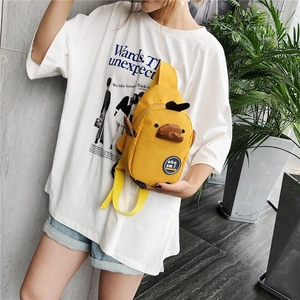 Cute yellow canvas cartoon duck crossbody chest bag worn by a model in casual style