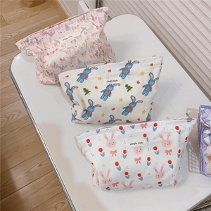 Three cute bunny canvas pouches with floral patterns and top zipper closure
