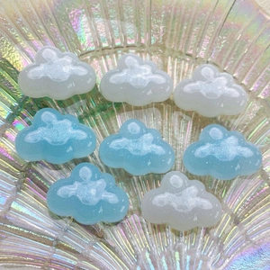 Glittering blue and white resin cloud charms for DIY accessories on iridescent tray