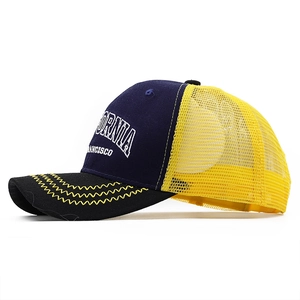Detail of contrast mesh trucker hat with California embroidery and wavy brim stitching