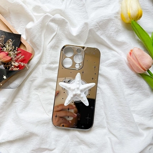 Glossy mirror iPhone case with a white 3D starfish pop socket and lucky text detail
