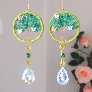 Green crystal suncatcher with woven tree of life and colorful butterfly accents