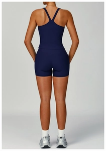 Rear view of navy blue ribbed yoga set featuring racerback tank and compression shorts