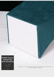 Detail view of the sturdy composite board base on the teal velvet jewelry display stand
