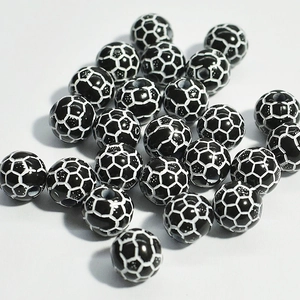 Detailed close-up of acrylic soccer-themed beads for DIY children's jewelry making