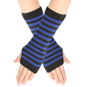 Close-up of blue and black striped knitted fingerless gloves worn on crossed arms