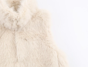 Detailed close-up of cream faux fur vest collar showing soft texture and high-quality fibers