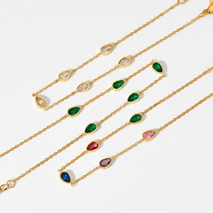 Gold stainless steel anklet with colorful pear-cut zircon pendants on white background