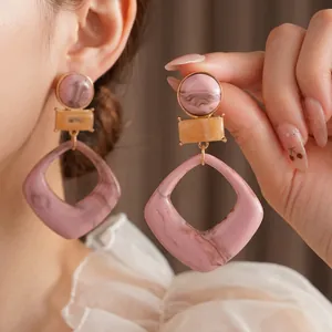 Pink marble and yellow resin geometric dangle earrings with a minimalist retro design