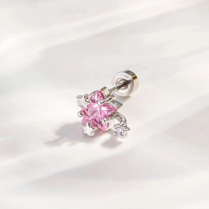 Pink star zircon stud earring in silver stainless steel with screw back on white fabric