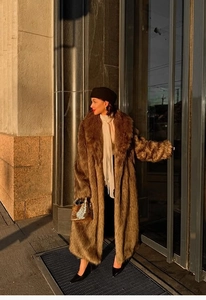 Close-up of luxury brown long faux fur coat with oversized lapels and premium texture