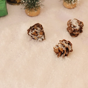 Miniature Christmas set with snow-covered pine cones and tiny trees for DIY winter scenes
