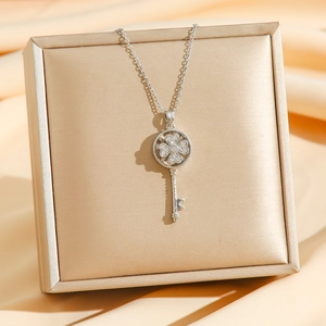 Elegant rotating four-leaf clover key necklace with cubic zirconia in silver steel finish