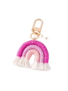Detail of handmade deep pink and white cotton woven rainbow keychain with gold metal ring
