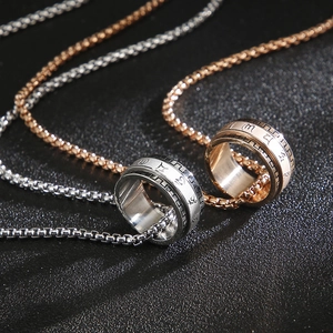 Detailed shot of rotating stainless steel rings with engraved symbols on a box chain
