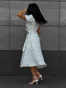 Detail of waist tie and puff sleeves on white floral A-line summer midi dress