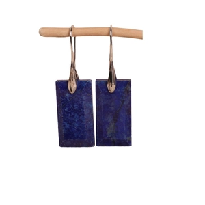 Elegant silver rectangle drop earrings featuring deep blue natural stone texture on a wooden stand