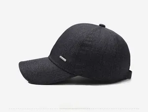 Side view of winter charcoal grey baseball cap showing textured fabric and metal logo plate