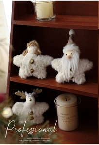 Detail of plush Christmas star ornaments with Santa, Angel and Reindeer on a wooden shelf