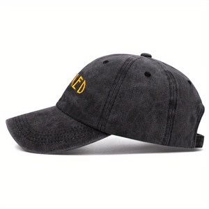Dark charcoal washed cotton baseball cap with yellow letter embroidery and curved brim