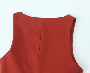 Detail of caramel sleeveless top neckline with vertical seam and woven fabric texture