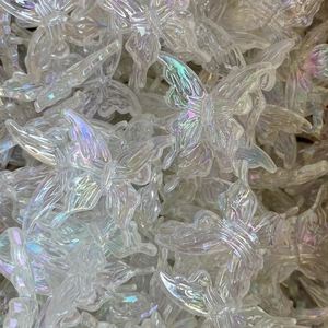 Macro shot of bulk transparent iridescent acrylic butterfly beads for jewelry making