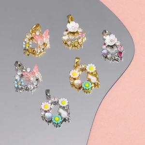 Detailed view of zircon-inlaid butterfly and daisy pendants on a reflective surface
