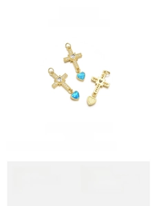 Detail of 18K gold plated heart cross pendant with blue opal and clear cubic zirconia