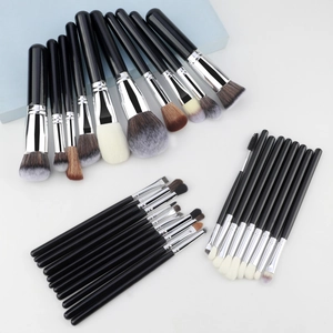 Close-up of 30pcs professional makeup brushes with black handles and silver ferrules