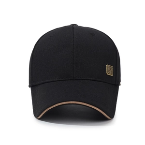 Minimalist black baseball cap with a gold metal plate and contrast brim edge detail
