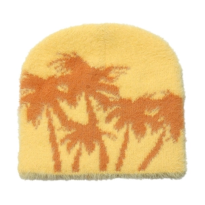 Detail view of yellow knit beanie with palm tree jacquard and soft faux mink fur texture