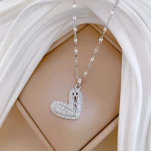 Macro view of a luxury heart pendant necklace with shimmering crystals on a jewelry box