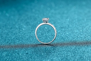 Macro shot of 925 sterling silver ring featuring a radiant cut emerald moissanite stone
