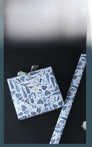 Close-up of Father's Day gift wrap with neckties and glasses pattern and silver ribbon