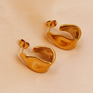 Detail of 18K gold plated stainless steel earrings with irregular twisted texture