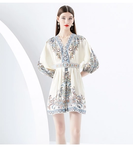 Close-up of V-neck printed mini dress with matching waist belt and paisley patterns