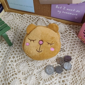 Mini plush brown bear coin purse with zipper and metal ball chain on lace fabric