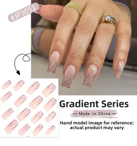 Detail of French ombré press-on nails with marble texture in nude brown long square shape