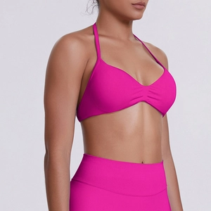 Detail of high-waist seamless rose pink sports leggings and halter yoga bra set