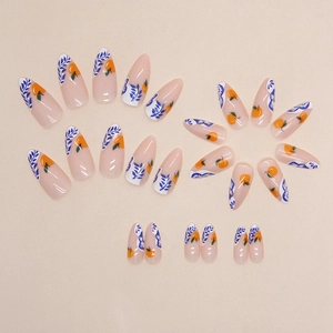 Almond press-on nails with orange persimmon and blue leaf hand-painted designs